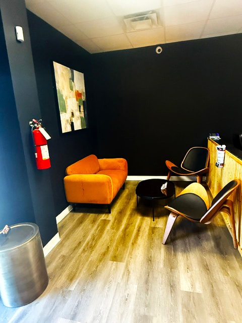 Golder Bail Bonds break room with black walls and orange furniture